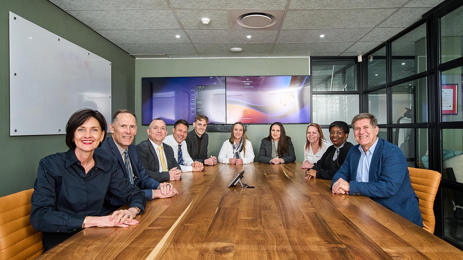 The ten members of the XPert Wealth team seated around the boardroom table
